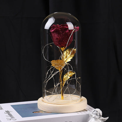 Light-up red eternal rose in glass dome glowing in the dark